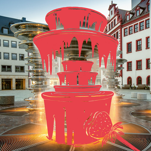 A digitally altered image of a city square with modern architecture, featuring a bright red overlay of a multi-tiered chocolate fountain and a strawberry illustration in the foreground.